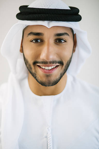 vertical portrait of young arab man dressed in traditional clothing